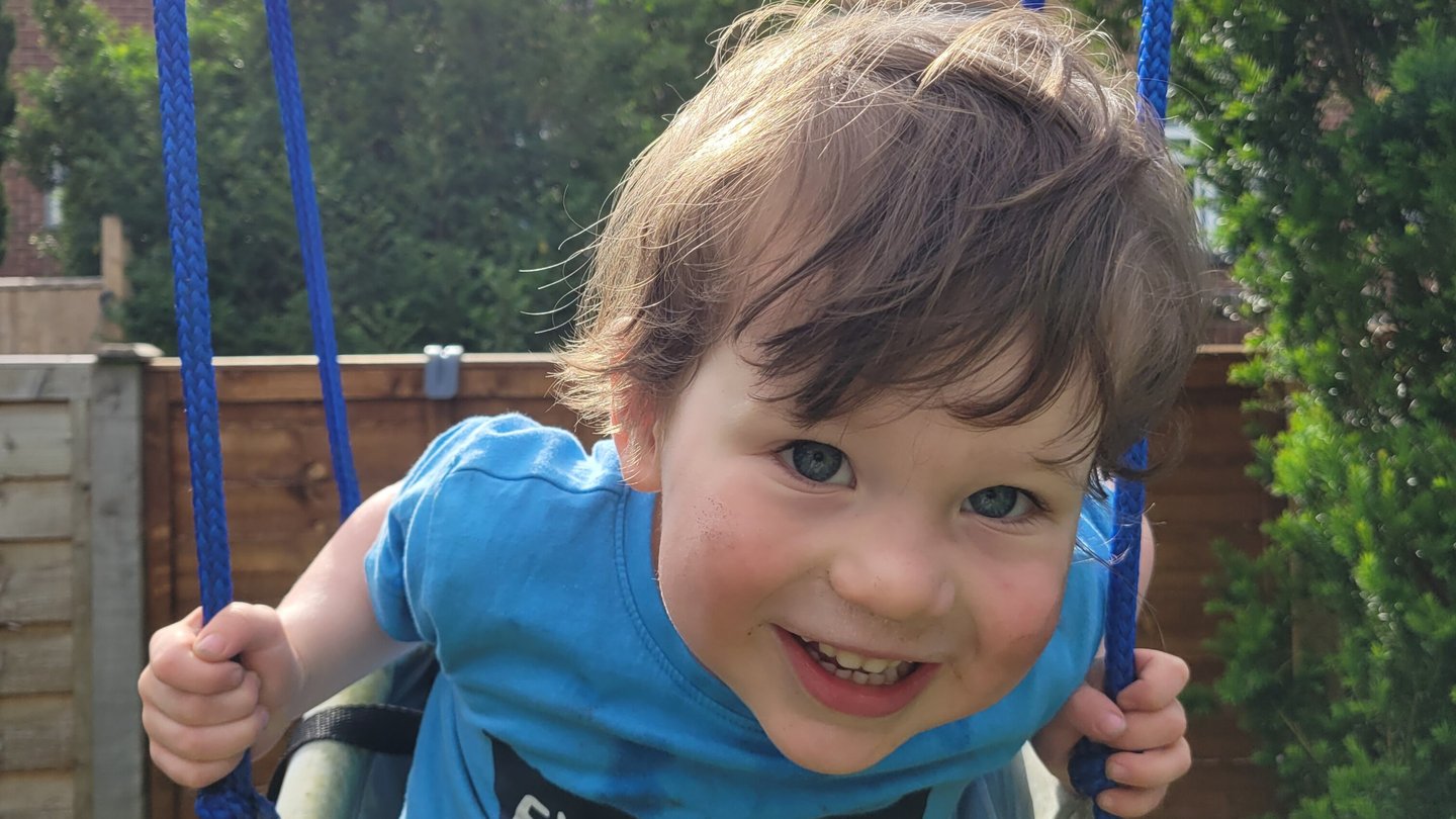 Young child playing on a swing