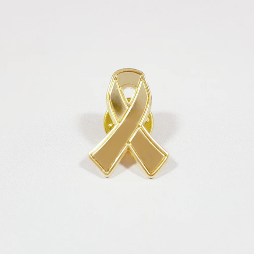 Image of gold ribbon pin badge representing Childhood Cancer Awareness Month