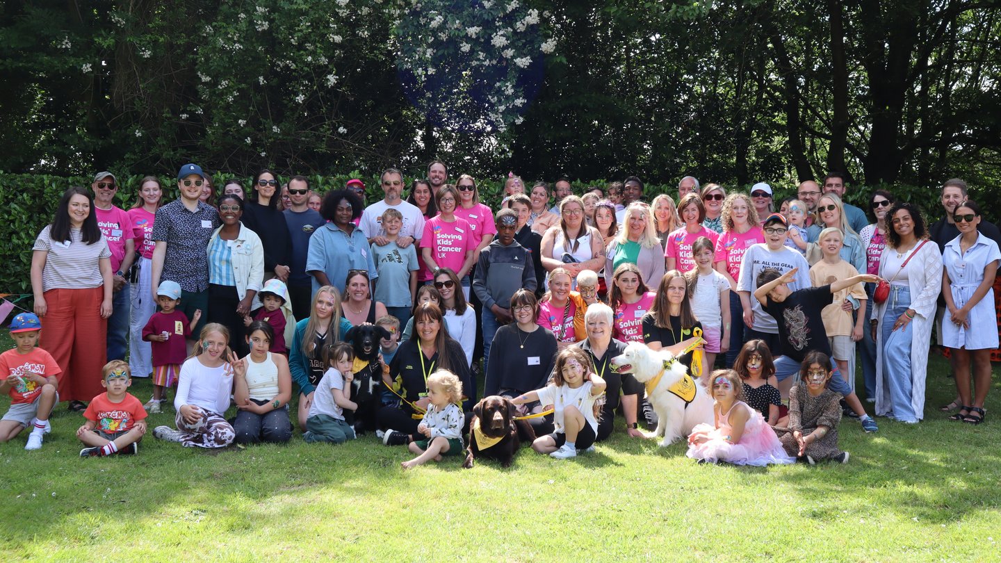 Group photo of families and staff and Solving Kids' Cancer UK's Family Fun Day