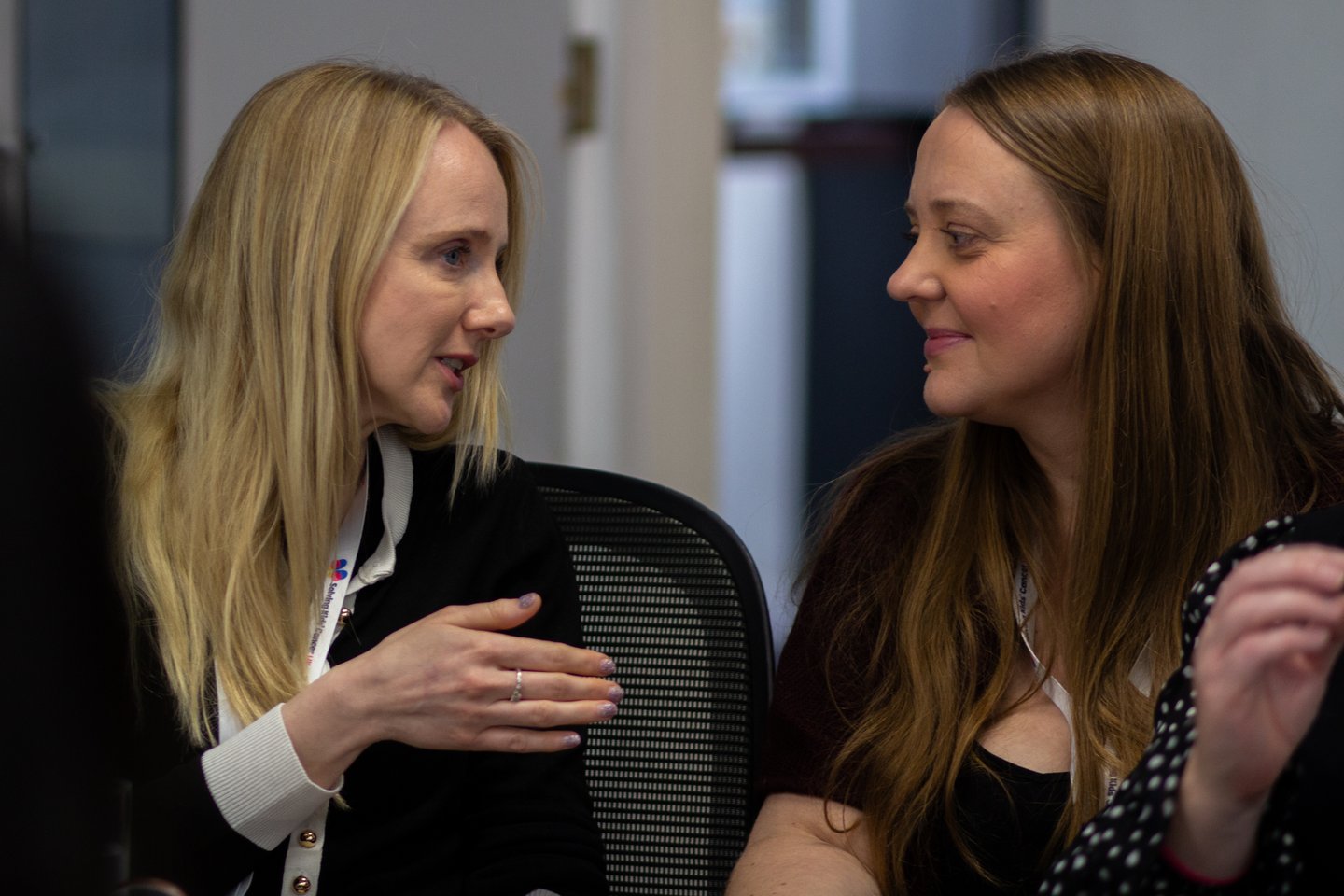 Two people talking to each other at Solving Kids' Cancer UK's Neuroblastoma Parent Symposium