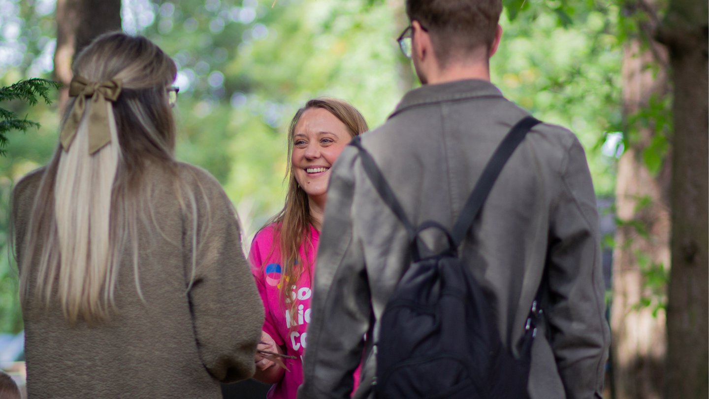 Photo of Solving Kids' Cancer UK Family Support Coordinator smiling and talking with a family