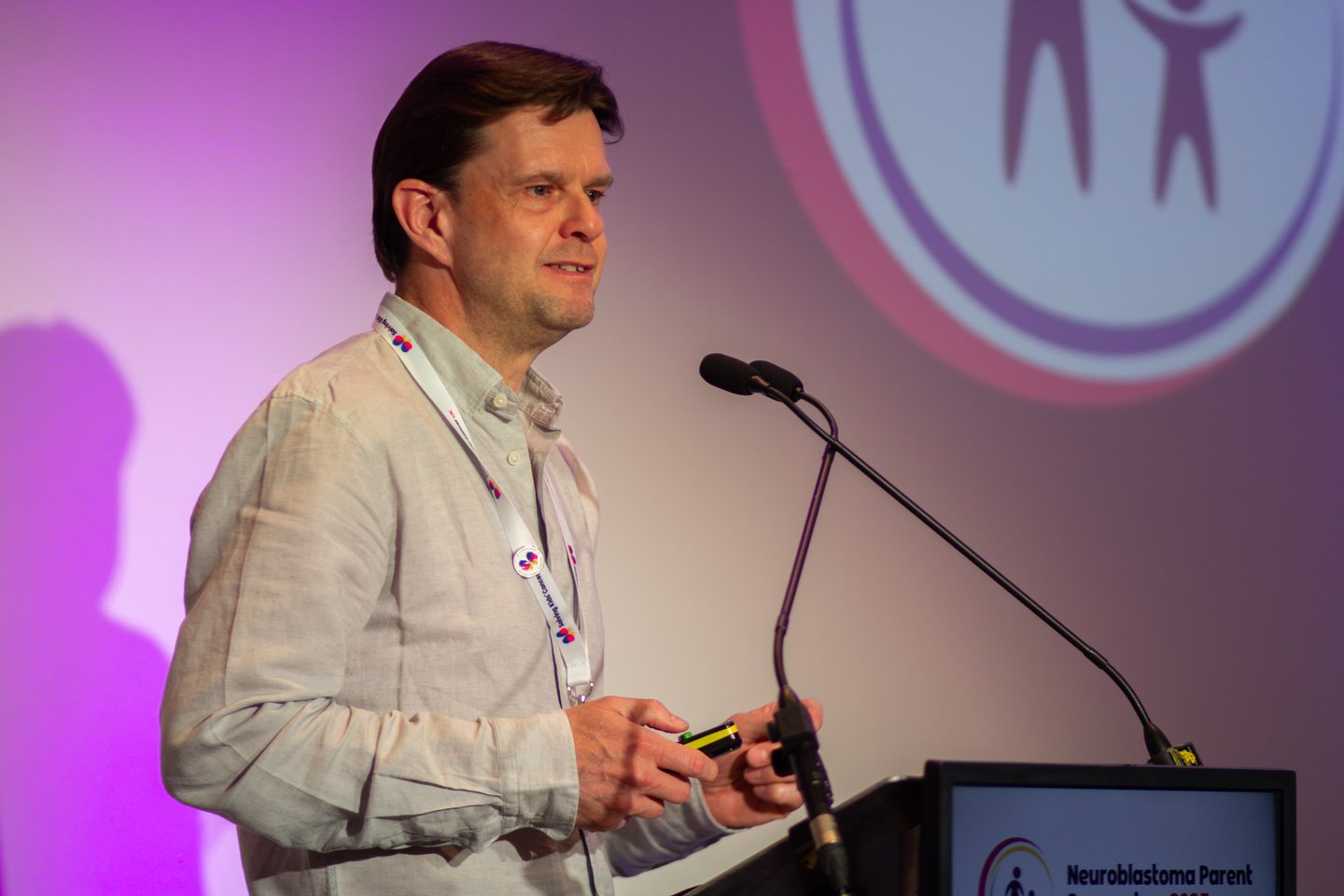 Research advocate and SKC UK Chair of Trustees, Nick Bird, presenting at a neuroblastoma conference.