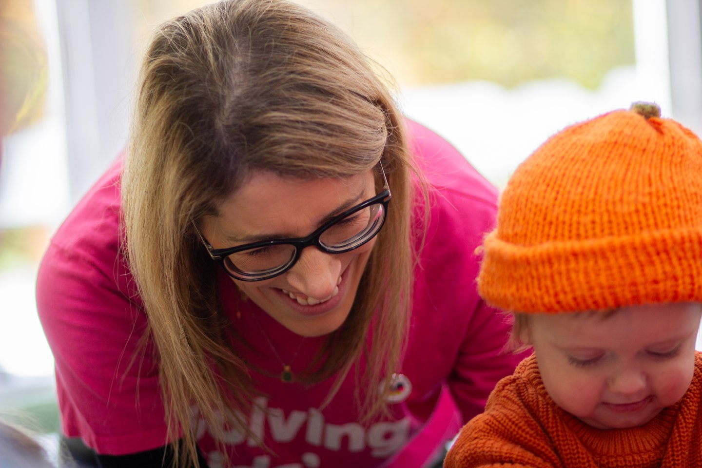 Picture of Solving Kids' Cancer UK's Family Support Coordinator and a child at a charity event