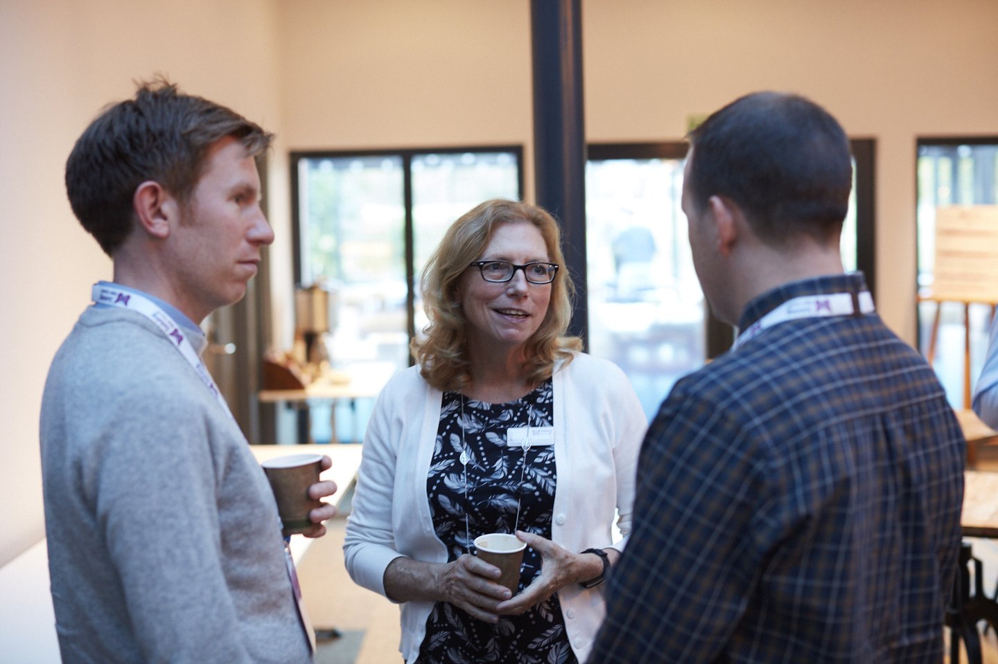 Solving Kids' Cancer UK's Family Support Advocate talking to parents at a charity conference