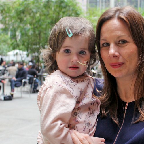 Isla in New York being held by her mum